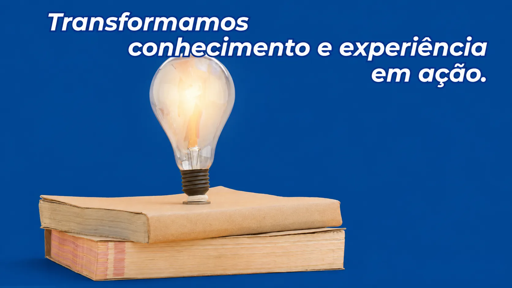 A lit lightbulb resting on a stack of books, symbolizing knowledge and experience